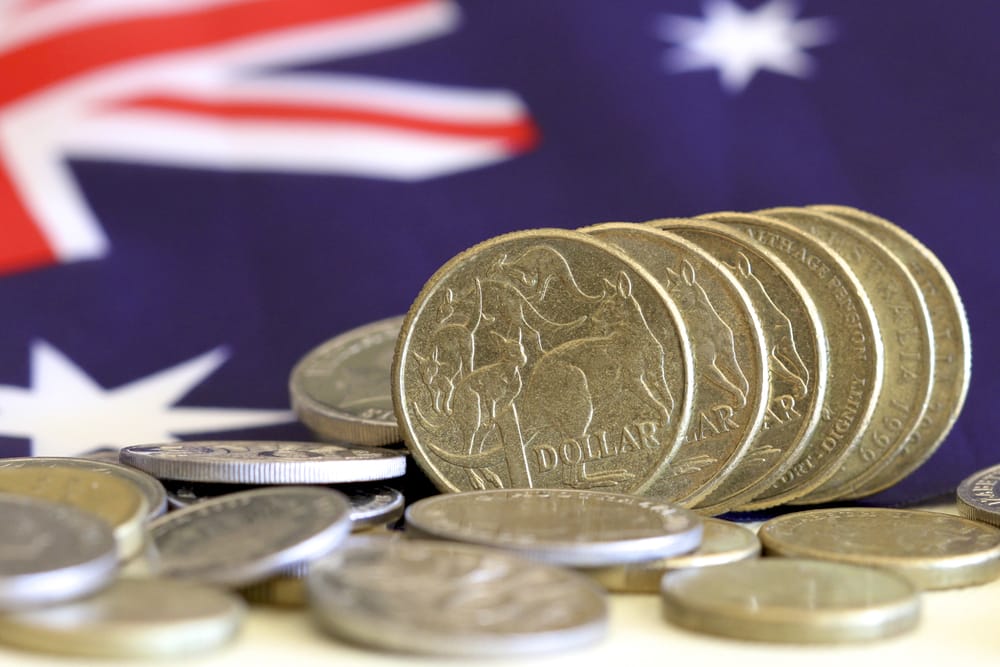 Australian flag with Australian dollars and coins in the foreground
